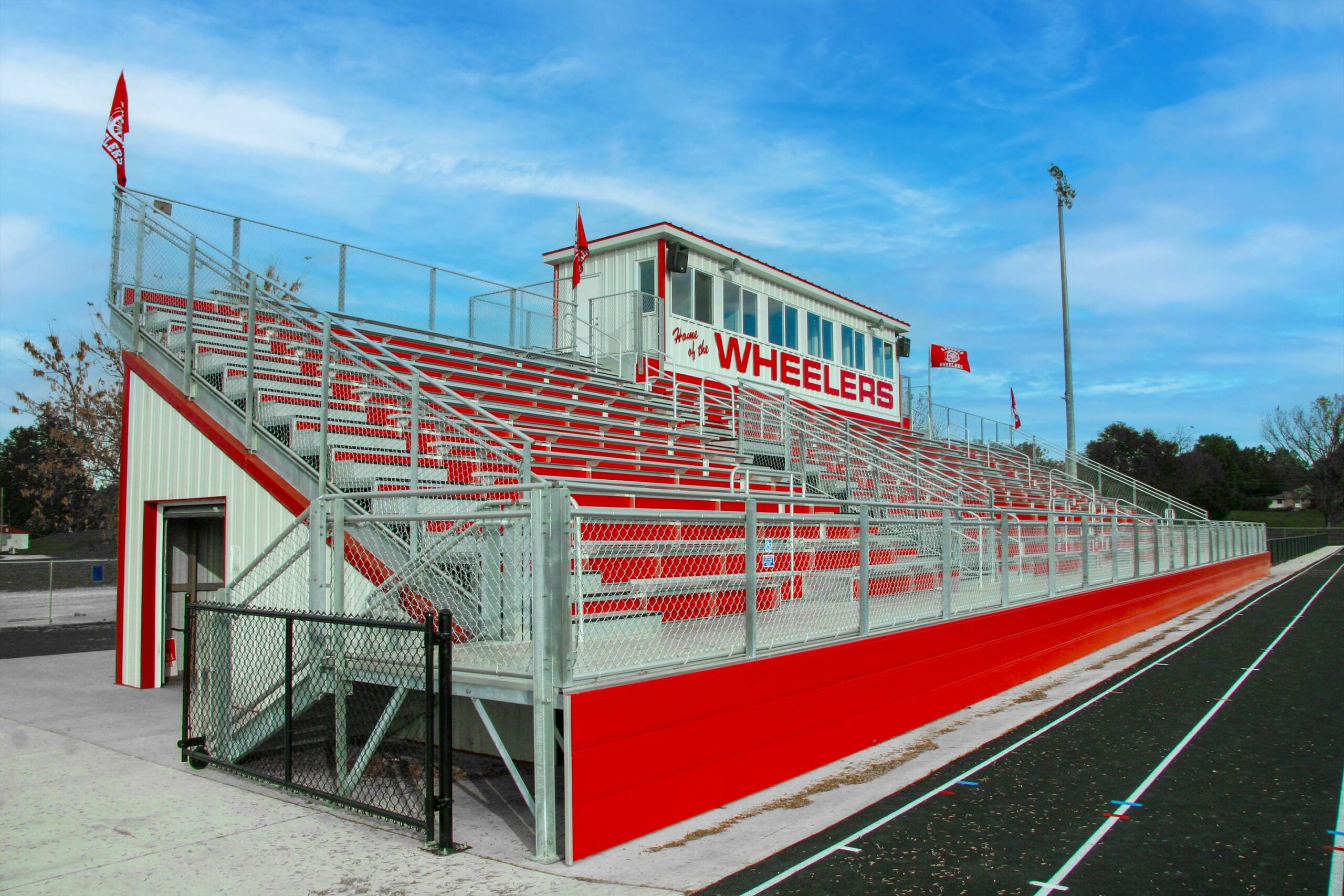 Red outdoor football bleachers for Central Iowa school.