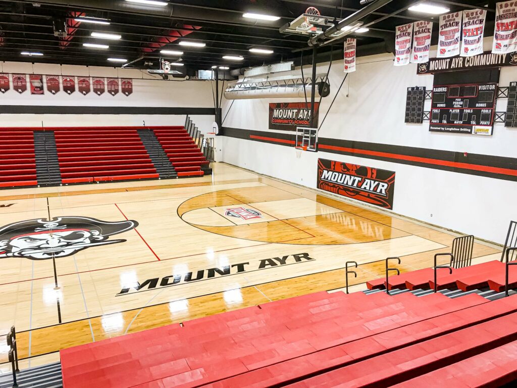 Red bleachers in high school gym located in Central Iowa.